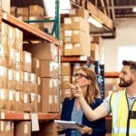 Warehouse staff comparing 3PL warehouse Melbourne storage racks and pallets