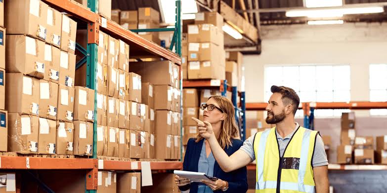 Warehouse staff comparing 3PL warehouse Melbourne storage racks and pallets